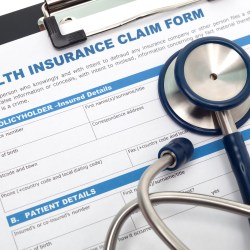 Medical and health insurance claim form with stethoscope on clipboard